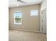 Cozy bedroom featuring bright windows and neutral carpet at 7776 Rigby St, Windermere, FL 34786