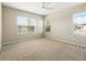 Neutral bedroom with natural light, carpet flooring, and a ceiling fan for added comfort at 7776 Rigby St, Windermere, FL 34786