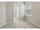 Neutral bedroom featuring a window with blinds and an open door to the bathroom at 7776 Rigby St, Windermere, FL 34786