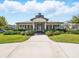 Community clubhouse featuring welcoming entrance, lush landscaping, and communal spaces at 7776 Rigby St, Windermere, FL 34786