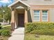 A close-up of the home's entrance with manicured landscaping at 7776 Rigby St, Windermere, FL 34786