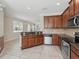 Spacious kitchen flows into the living room, with stainless steel appliances and granite countertops at 7776 Rigby St, Windermere, FL 34786