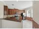 Beautiful kitchen with stainless steel appliances, granite countertops, and wooden cabinetry at 7776 Rigby St, Windermere, FL 34786