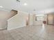 Spacious living room area showcasing tile flooring and a modern staircase at 7776 Rigby St, Windermere, FL 34786