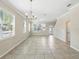 Bright and spacious living area with tile flooring and plenty of windows at 7776 Rigby St, Windermere, FL 34786