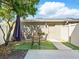 Inviting outdoor patio with artificial turf, seating, and a shade umbrella at 7776 Rigby St, Windermere, FL 34786