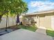 Inviting outdoor patio with artificial turf, seating, shade umbrella and an exterior door at 7776 Rigby St, Windermere, FL 34786