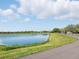 Tranquil pond with walking path, ideal for peaceful strolls and enjoying nature views at 7776 Rigby St, Windermere, FL 34786