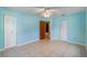 Bedroom with two closets, light blue walls, tile flooring and ceiling fan at 913 Jacaranda Dr, Lady Lake, FL 32159