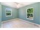 Bedroom with tile flooring, two windows and ceiling fan at 913 Jacaranda Dr, Lady Lake, FL 32159