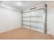 Single car garage with block walls, carpet and white door at 913 Jacaranda Dr, Lady Lake, FL 32159