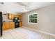 Cozy kitchen featuring wooden cabinets, black appliances, and a bright window at 913 Jacaranda Dr, Lady Lake, FL 32159