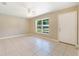 Bright living room with neutral walls, tiled floors, a ceiling fan, and a large window at 913 Jacaranda Dr, Lady Lake, FL 32159