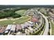 Overhead view highlighting luxury homes with golf course access, interwoven with manicured streets and vibrant landscaping in a community at 942 Jack Nicklaus Ct, Kissimmee, FL 34747