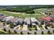 Luxury homes with manicured landscaping, complemented by a lush golf course and scenic streetscapes from an aerial perspective at 942 Jack Nicklaus Ct, Kissimmee, FL 34747