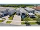 Aerial view of a modern home featuring a paver driveway and mature landscaping at 942 Jack Nicklaus Ct, Kissimmee, FL 34747