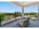 Balcony featuring comfortable seating and a view of a pond and neighborhood at 942 Jack Nicklaus Ct, Kissimmee, FL 34747