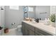 Clean bathroom with gray vanity, a white quartz counter, and stylish neutral decor at 942 Jack Nicklaus Ct, Kissimmee, FL 34747