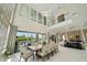 Elegant dining area featuring soaring ceilings, contemporary lighting, and expansive windows with pool views at 942 Jack Nicklaus Ct, Kissimmee, FL 34747