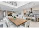 Open-concept dining area with a large wooden table, seating for ten, and modern decor that complements the living space at 942 Jack Nicklaus Ct, Kissimmee, FL 34747