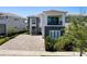 Two-story home showing modern architectural details, well-maintained landscaping, and a brick driveway at 942 Jack Nicklaus Ct, Kissimmee, FL 34747