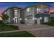 Stunning two-story home showcasing a modern design with stone accents and a spacious brick driveway at 942 Jack Nicklaus Ct, Kissimmee, FL 34747