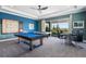 Recreational game room featuring a pool table, an air hockey table, and covered patio access at 942 Jack Nicklaus Ct, Kissimmee, FL 34747