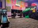 This fun game room features vibrant gaming decor, wall art, and comfortable gaming chairs at 942 Jack Nicklaus Ct, Kissimmee, FL 34747