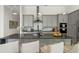 Beautiful kitchen features a center island with seating, stainless steel appliances, and modern cabinetry at 942 Jack Nicklaus Ct, Kissimmee, FL 34747