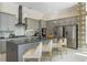 Modern kitchen boasts stainless appliances, a large island with seating, and stylish pendant lighting at 942 Jack Nicklaus Ct, Kissimmee, FL 34747