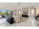 Spacious living room with stylish furniture, a large TV, and access to the outdoor pool area at 942 Jack Nicklaus Ct, Kissimmee, FL 34747