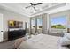 Airy main bedroom with windows providing ample natural light and a view of nature at 942 Jack Nicklaus Ct, Kissimmee, FL 34747