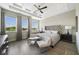 Bright main bedroom with tray ceilings, three windows, and sitting area at 942 Jack Nicklaus Ct, Kissimmee, FL 34747