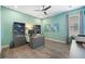 Modern office with a ceiling fan, built-in shelving, a desk, and light-blue colored walls at 942 Jack Nicklaus Ct, Kissimmee, FL 34747