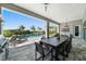This covered patio area features outdoor seating, grill, and pool views at 942 Jack Nicklaus Ct, Kissimmee, FL 34747