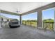 Spacious covered patio with scenic view, seating, and a hanging swing chair at 942 Jack Nicklaus Ct, Kissimmee, FL 34747