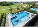 An aerial view of the pool and hot tub overlooking the golf course and landscaped yard at 942 Jack Nicklaus Ct, Kissimmee, FL 34747