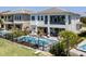 Stunning home featuring pool, outdoor seating, and manicured landscaping at 942 Jack Nicklaus Ct, Kissimmee, FL 34747