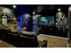 Home theater features custom Batman-themed mural, reclining seats, and a large screen at 942 Jack Nicklaus Ct, Kissimmee, FL 34747