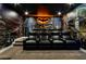 Home theater features luxury seating, a cityscape mural, and a Batman logo for a unique entertainment experience at 942 Jack Nicklaus Ct, Kissimmee, FL 34747