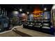 Home theater with tiered seating, a projector, and a Batman-themed decor for immersive viewing at 942 Jack Nicklaus Ct, Kissimmee, FL 34747
