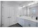 Bathroom with double vanity, white stone countertops, and gray cabinets at 1118 Eagles Pass Way, Winter Garden, FL 34787