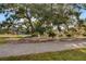 Community park with a walking path, lake view, mature oak trees, and Spanish moss at 1118 Eagles Pass Way, Winter Garden, FL 34787