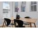 Cozy dining area features a wooden table with black chairs, illuminated by natural light at 1118 Eagles Pass Way, Winter Garden, FL 34787