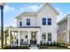 Inviting two-story home with covered front porch, rocking chairs, and a beautifully landscaped entrance at 1118 Eagles Pass Way, Winter Garden, FL 34787