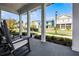 Relaxing front porch showcasing classic rocking chairs and a tranquil neighborhood setting at 1118 Eagles Pass Way, Winter Garden, FL 34787