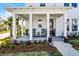 Welcoming front porch with comfortable seating, lush plants, and a charming neighborhood view at 1118 Eagles Pass Way, Winter Garden, FL 34787