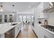 Bright kitchen with a view to the dining area featuring stainless steel appliances and white cabinetry at 1118 Eagles Pass Way, Winter Garden, FL 34787