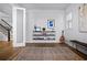 Stylish living room with hardwood floors, modern shelving, and ample natural light flowing through the glass doors at 1118 Eagles Pass Way, Winter Garden, FL 34787