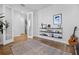 Elegant living room with hardwood floors, modern shelving, and glass doors, offering a seamless transition to other areas at 1118 Eagles Pass Way, Winter Garden, FL 34787